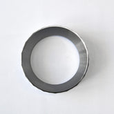A bird's eye view looking directly through the hollow center of the WENDOUGEE 58mm portafilter ring on a plain background.