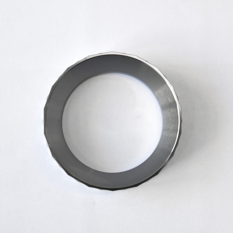 A bird's eye view looking directly through the hollow center of the WENDOUGEE 58mm portafilter ring on a plain background.